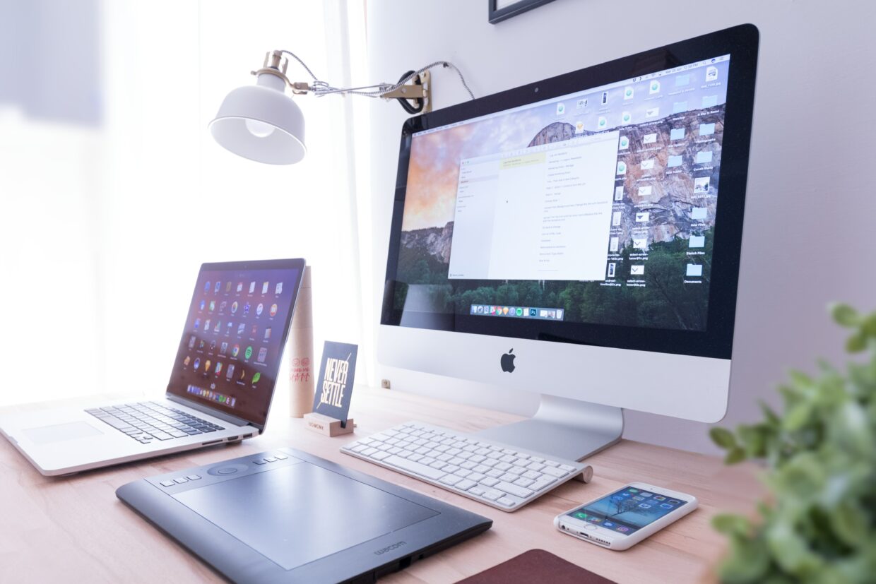 A computer, phone, and laptop